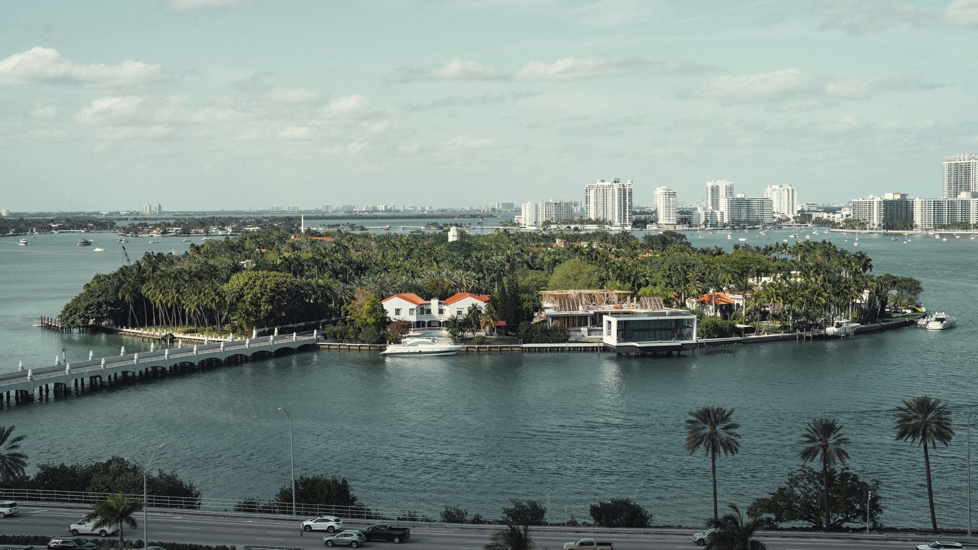 Island of waterfront houses with docks and boats seen from above